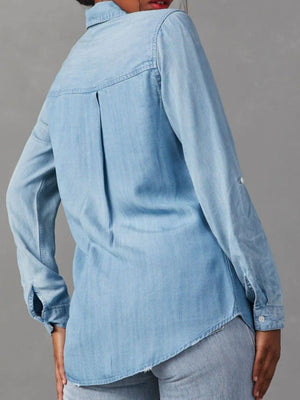 Light blue washed denim utility shirt with buttoned cuffs and back pleat detail.