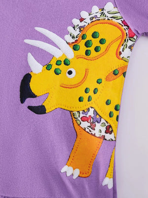 Toddler purple cotton crew neck dress with yellow dinosaur applique and floral accents.