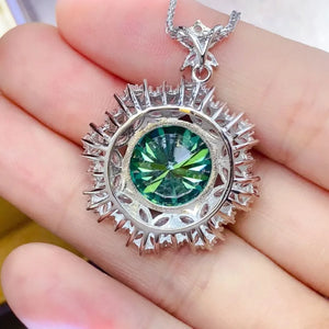 Silver halo necklace with a round green moissanite center stone and sparkling accent stones.