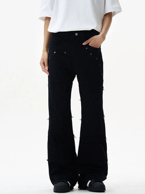 Black stretch flare jeans with frayed hem details and a wide leg cut.