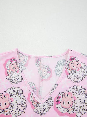 Pink V-neck pajama top with a festive Santa Claus print and snowflakes.