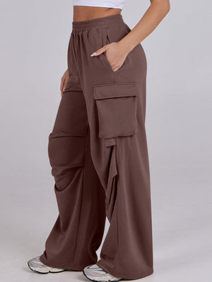 Cargo pocket drape wide leg pants in dark brown with elastic waist and side pockets.