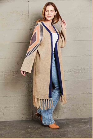 Khaki long cardigan with geometric trim, navy blue trim, and fringed hemline.