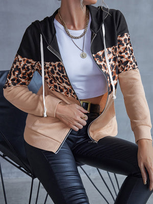 Colorblock leopard zip-up hoodie with black, tan, and leopard print panels.
