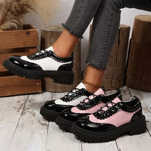 Round toe platform loafers in white and pink with brogue detailing and chunky soles.