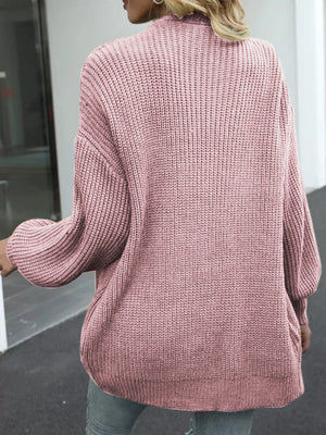 Dusty pink chunky knit cocoon cardigan with balloon sleeves and ribbed texture.