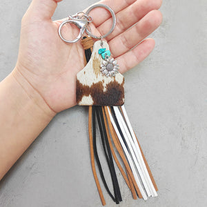 Leopard print tag keychain with multi-color tassels, turquoise stone, and sunflower charm.