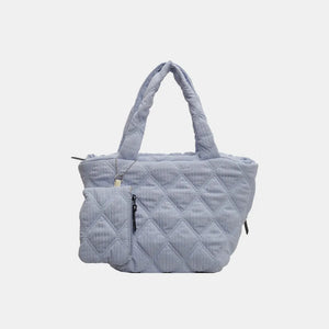 Quilted shopper tote bag in light blue with diamond pattern and attached coin purse.