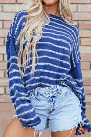 Blue striped relaxed fit knit sweater with crew neck and long sleeves.
