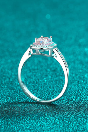 Silver ring with oval halo and pink stone accents.