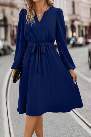 Navy midi dress with V-neck, poet sleeves, and tie waist