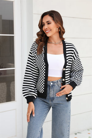 Checkerboard sleeve contrast cardigan in black and white with button front and striped sleeves.