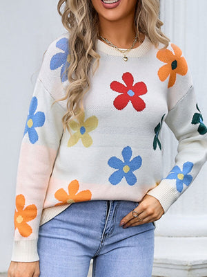 White knit crewneck sweater with colorful floral pattern.