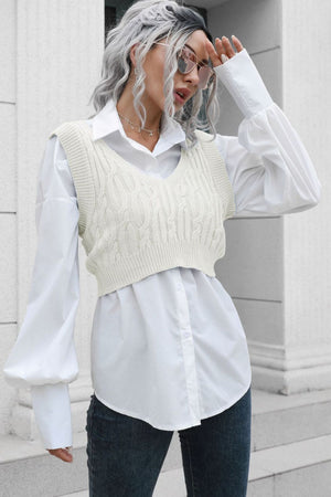 Cream cable knit v-neck cropped vest with white button-up shirt and jeans