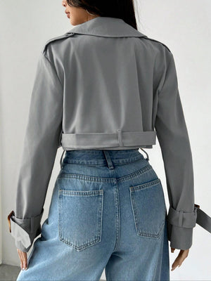 Gray cropped double-breasted trench coat with belt and adjustable cuffs.