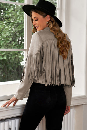 Gray suede cropped jacket with fringe details and long sleeves.