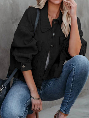 Black waffle knit cropped utility jacket with button front and chest pockets.