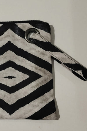 Clutch bag with black and white abstract print and grommet wristlet detail