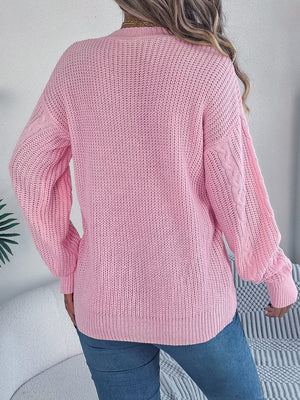 Blush pink cable knit cardigan with balloon sleeves and buttoned front, acrylic.