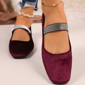 Elegant square toe slip-on flats in velvet with rhinestone strap detail.