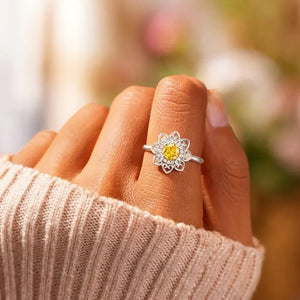 Silver floral filigree ring with yellow and clear zirconia stones.