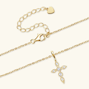 Gold diamond-set cross pendant necklace with adjustable chain and lobster clasp.