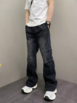 Distressed black wide-leg jeans for men with vintage wash and panel details.