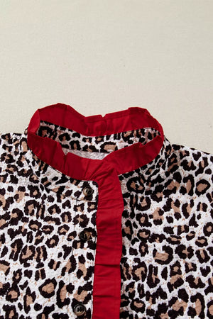 Leopard print polyester shirt with red frilled V-neck and buttons