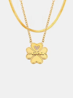 Gold layered necklaces with clover charm and crystal heart detail