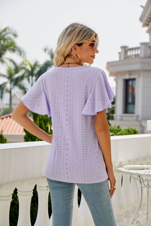 Lilac eyelet flounce sleeve crew neck top with intricate patterned cutouts.