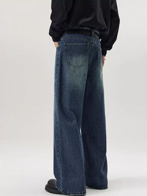 Men's wide-leg wash denim jeans in dark blue, relaxed fit, casual style.