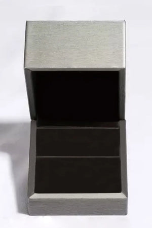 Open dark green ring box with silver-toned exterior