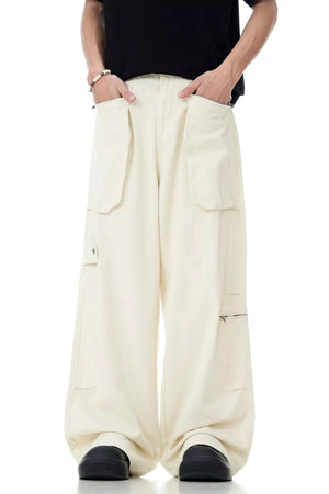 Relaxed cream cargo pants for men with multiple pockets and zipper details.
