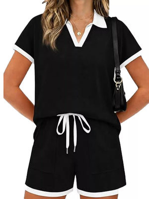 Black polo collar two-piece set with white trim and drawstring shorts.