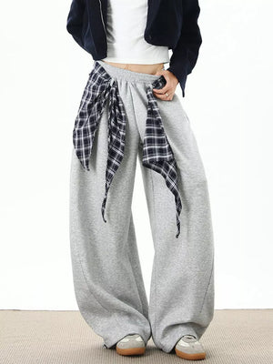 Grey relaxed fit wide-leg sweatpants with plaid tie detail.