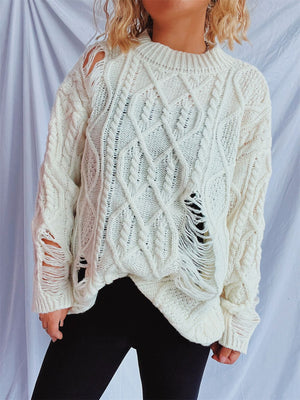 White distressed cable knit sweater with ripped details and fringe.