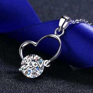 Silver heart halo pendant necklace with a round crystal charm spelling out "love".