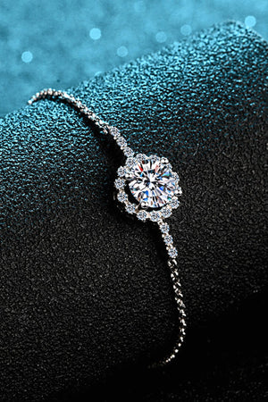 Silver adjustable bracelet with a central round-cut crystal flower design and smaller crystal accents.