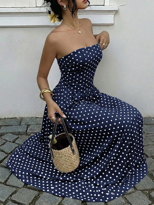 Navy polka dot A-line maxi dress with sweetheart neckline and cinched waist detail.