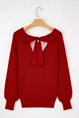 Red knit sweater with backless detail and large satin bow.