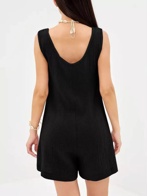Black crinkled cotton sleeveless button-down romper with a V-neckline and shorts.