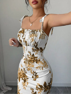 Floral print tie strap maxi dress in white with brown floral pattern, ruched bodice and square neckline.