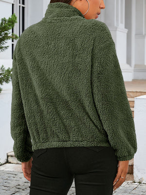 Green sherpa bomber jacket with a stand-up collar and elastic cuffs.