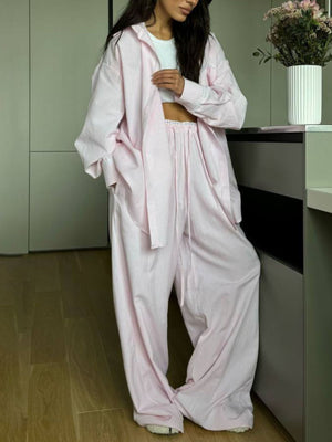 Pinstriped long sleeve pajama set in dusty pink with drawstring pants and button-down shirt.