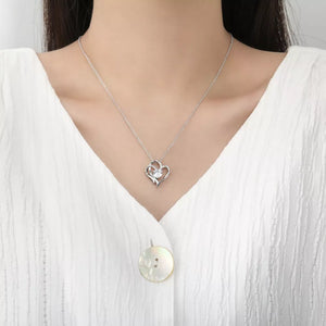 Elegant heart pendant necklace in sterling silver with a clear stone detail.