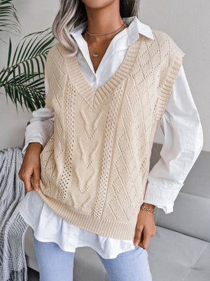 Cream openwork cable knit vest with V-neck and diamond pattern detail.