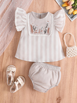 Baby two-piece set with floral embroidery, striped top, bloomer shorts, and ruffled sleeves.
