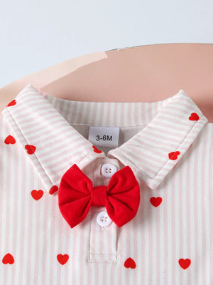 White striped baby bodysuit with red hearts and a red bow detail.