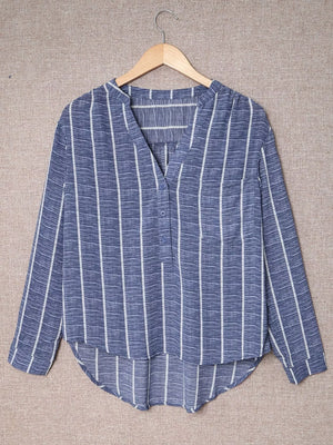 Dusty blue striped V-neck buttoned blouse with long sleeves and a curved hem.