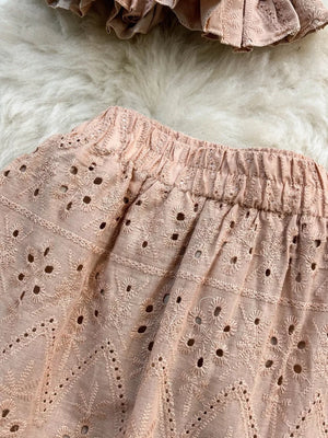 Pink eyelet crop top and maxi skirt set with elastic waistband detail.